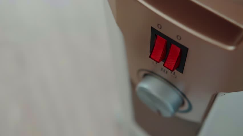 Turning on and adjusting the temperature on the electric heater panel, close-up. The concept of heating a room without heating during the cold season. Copy space for text Royalty-Free Stock Footage #1109168967