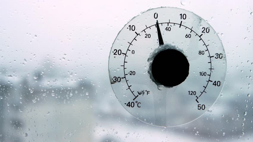 Raindrops and sleet on a thermometer outside the window that shows the air temperature outside. Weather forecast, thaw in winter beginning of spring. Copy space for text | Shutterstock HD Video #1109169135