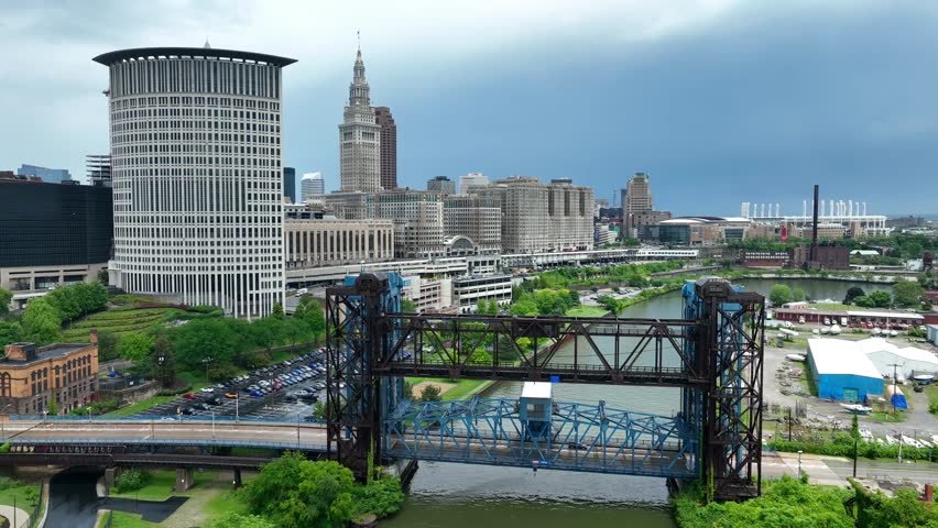 Downtown Cleveland, Ohio riverfront. Old steel bridges over Cuyahoga River with inner city skyline in distance.