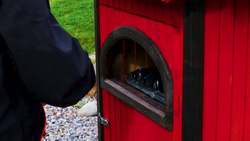 Person recycling in red trashcan