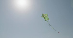 A close-up of a kite flying across the sky. Fun children's games in the air. High quality 4k footage