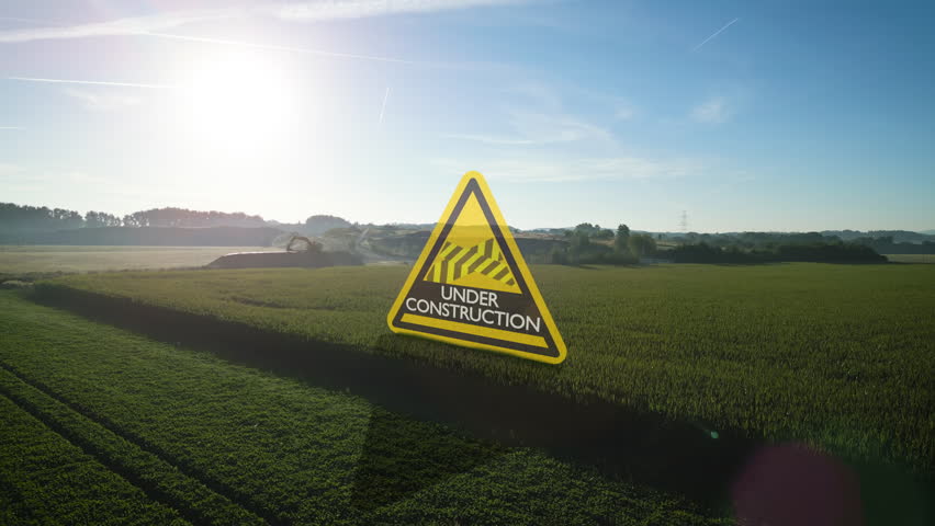 Flight through digital 3D under construction sign in front of green cornfield and mining area and construction site in background Royalty-Free Stock Footage #1109174977