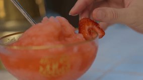 This close up video shows an anonymous bartender hand garnishing a frozen cocktail rim with strawberry fruit. - Powered by Shutterstock - Get 15% off with code: PIKWIZARD15