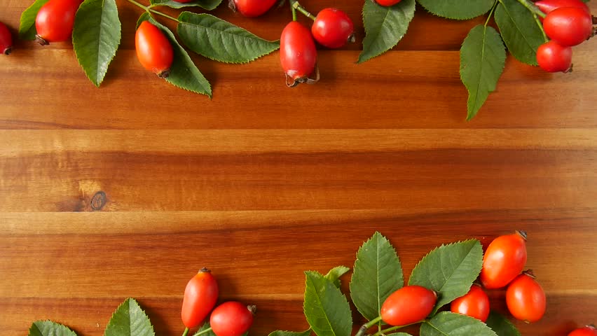 Rose hips with leaves on a board. Royalty-Free Stock Footage #1109176637