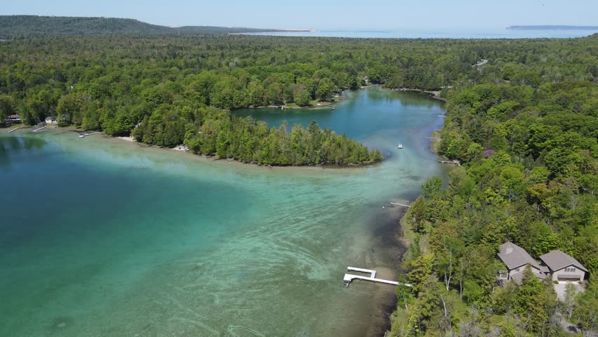 Beauty of Fisher lake in Michigan with private property on shoreline, aerial view