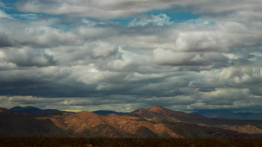 Daytime cloudscape time lapse over mountains beyond the Mojave Desert basin