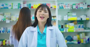 Female pharmacist talking with customer in drugstore. She explaining detail about drug in pharmacy. 