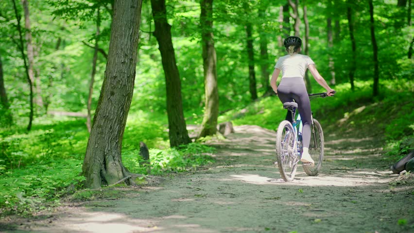 Woman riding on bike in park | Shutterstock HD Video #1109183397