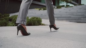 Close up of female employee wearing formal clothes and high heels walking near office building. Attractive caucasian woman elegantly climbing street stairs and heading to personal workplace. - Powered by Shutterstock - Get 15% off with code: PIKWIZARD15