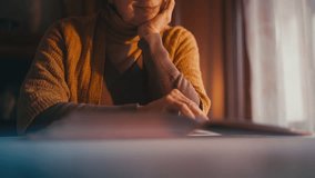 Senior lady looking at photos in album, turning page and smiling, happy memories - Powered by Shutterstock - Get 15% off with code: PIKWIZARD15