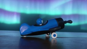 A blue toy airplane for boys with a pilot inside on a wooden table. The cosmic environment. The concept of aviation. 3D animation. 3D Illustration - Powered by Shutterstock - Get 15% off with code: PIKWIZARD15