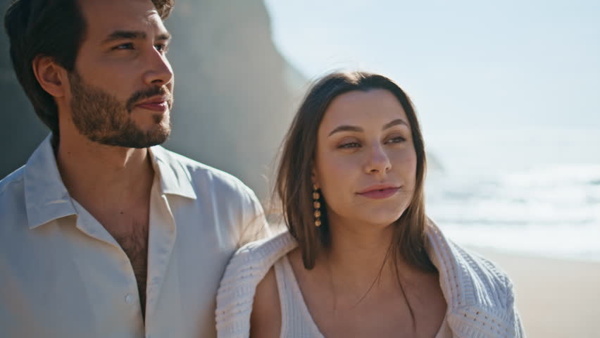 Smiling lovers walking seashore sunny holiday close up. Carefree young couple looking each other feeling love at summer beach. Happy relaxed spouses spending time together at beautiful ocean coast. Royalty-Free Stock Footage #1109187531