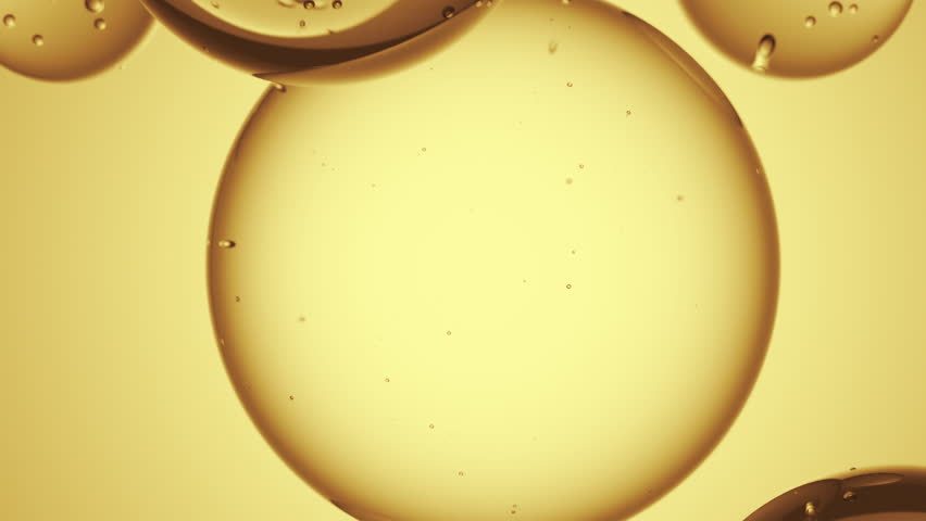 Cosmetics golden serum liquid bubbles abstract background. Cosmetic moisturizer essence gel. Collagen fluid bubble molecule. Moisturizing cream or oil for personal health care and beauty skin concept
