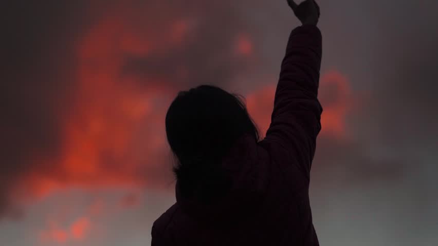 Sunset silhouette of young teenager girl show rock n roll gesture by hands cool sign.  Rejoicing in success. Hand gesture orange clouds in sky.  Royalty-Free Stock Footage #1109190349