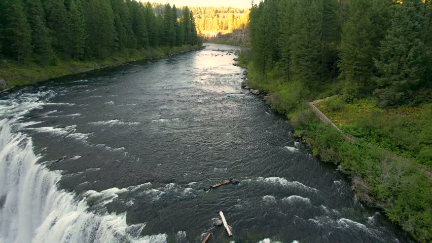 Drone Aerial pulling back of the Upper Mesa Falls, a thunderous curtain of water – as tall as a 10-story building Near Island Park, and Ashton, Idaho