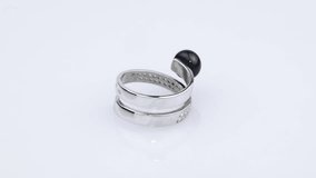Rotating silver ring with reflection on white background. Video rotation 360.