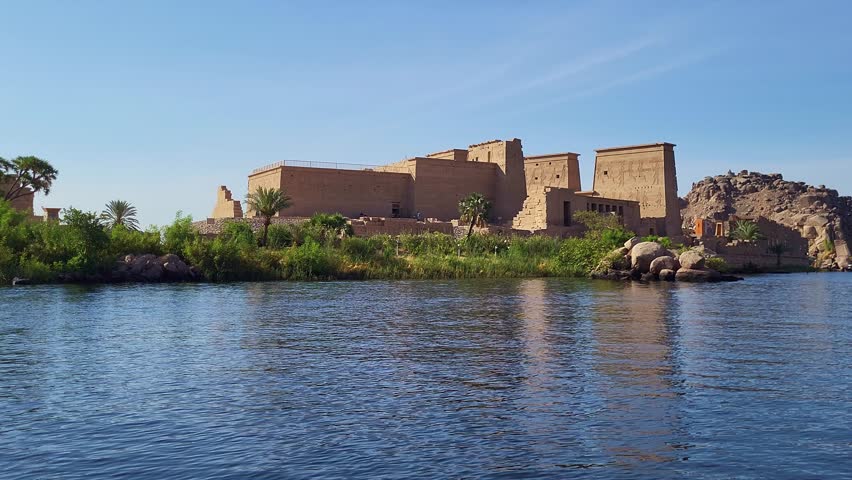 Temple of Philae exterior panoramic from the Nile river at dawn. View of the monument from a barge on the Nile River.