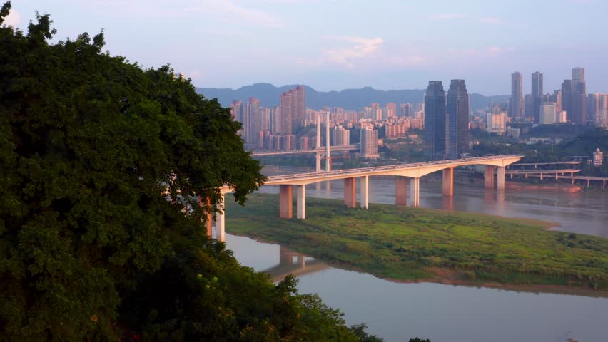 Large bridge linking Chongqing chinese city at sunset. Aerial view
