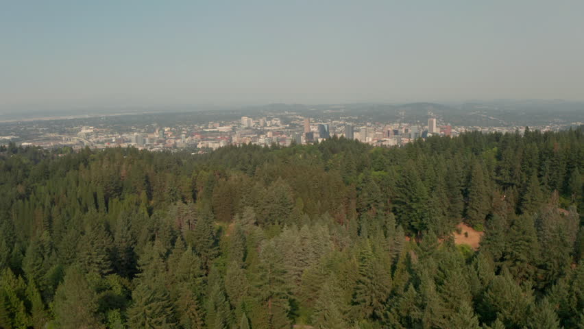 Low aerial shot over Forest park towards Portland Oregon