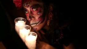 Gorgeous Calavera Catrina in a festive rich dress and headdress stands in the castle with a candle in her hand. Sugar skull girl. Day of The Dead. Halloween. Dia de los Muertos. Santa Muerte. - Powered by Shutterstock - Get 15% off with code: PIKWIZARD15