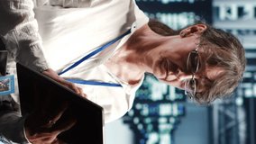 Vertical video Senior programmer working in data center housing GPU dedicated server cabinets that can process artificial intelligence tasks with high efficiency, fixing defective machines used for - Powered by Shutterstock - Get 15% off with code: PIKWIZARD15