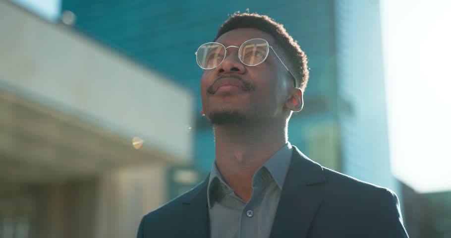 Black man in business, thinking about future ideas and corporate employee outdoor, dream and inspiration. Insight, decision and brainstorming with goals, mind with travel or commute to work in city Royalty-Free Stock Footage #1109202455