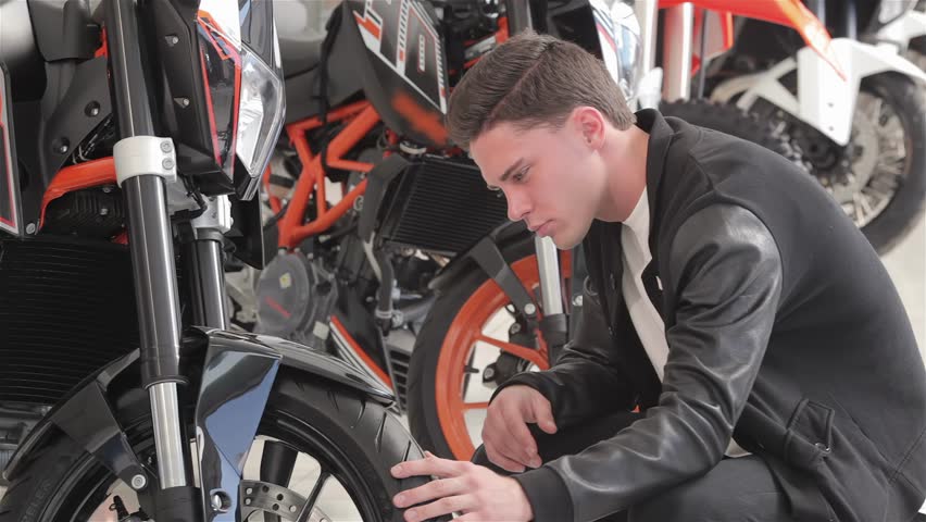 Close up of a young client examines motorbike