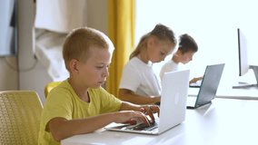 Group of children at school online learning. Teamwork of children with laptop online learning as a team. Children learn together at school to work as team with laptop.Team learning at school in lesson
