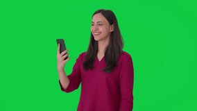 Happy Indian woman talking on video call Green screen