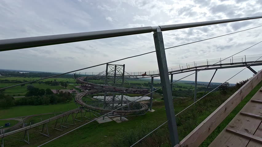 POV From Amusement Park Ride Ascending On Loop. Roller Coaster.