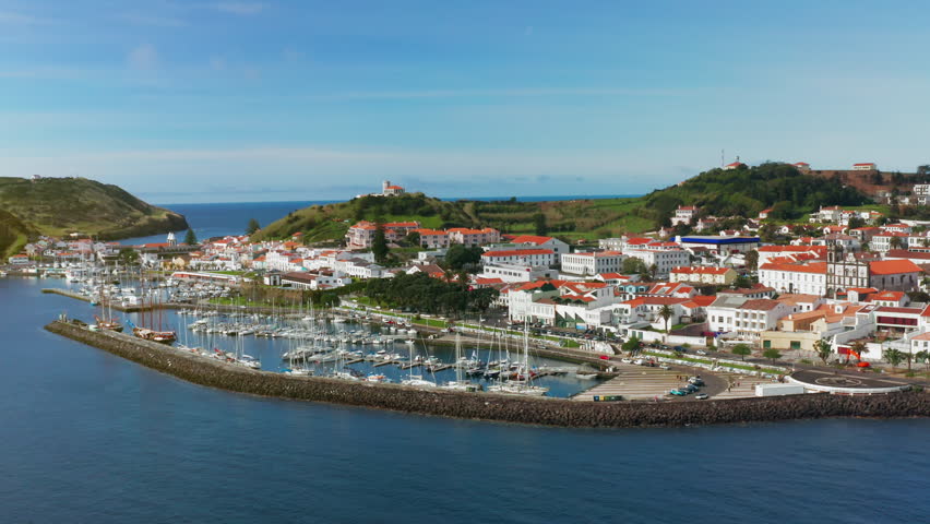 Cinematic aerial drone shot of picturesque local town of Horta in Faial island, Azores - Portugal
High view of the ships docked at the harbor, green landscape in the background. Royalty-Free Stock Footage #1109214275