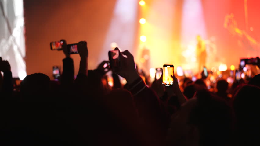 Lot fun people record music video use mobile phone. Fan crowd shoot k pop live concert. Many men hang out cool rave fest. Joy group chill night club hall. Dj star raise hand up. Make neon light photo.