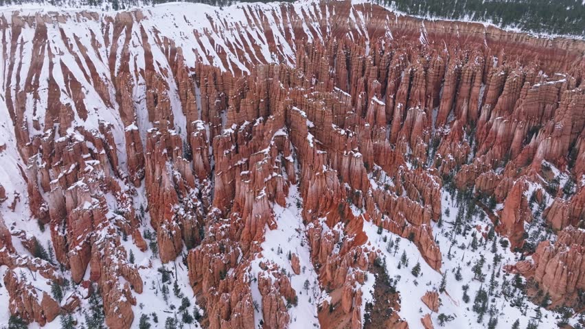 Natural Amphitheater With Snow In Winter In Bryce Canyon National Park, Utah, USA. aerial orbit