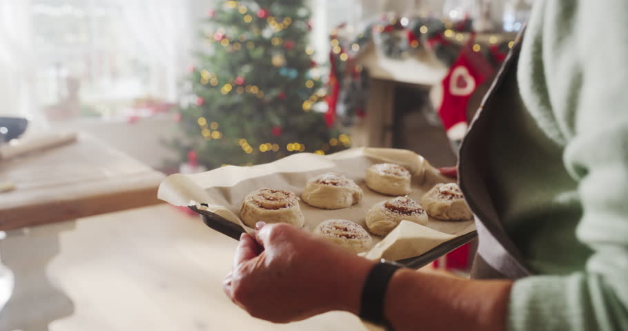 Slow Motion Portrait of Senior Female Preparing Dough for Making Gingerbread for Christmas at Home. Cheerful Housewife and Grandmother Making Pastries to Share with Family and Friends for the Holiday Royalty-Free Stock Footage #1109217939