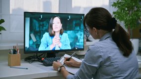 Psychologist in online therapy meeting with young female patient