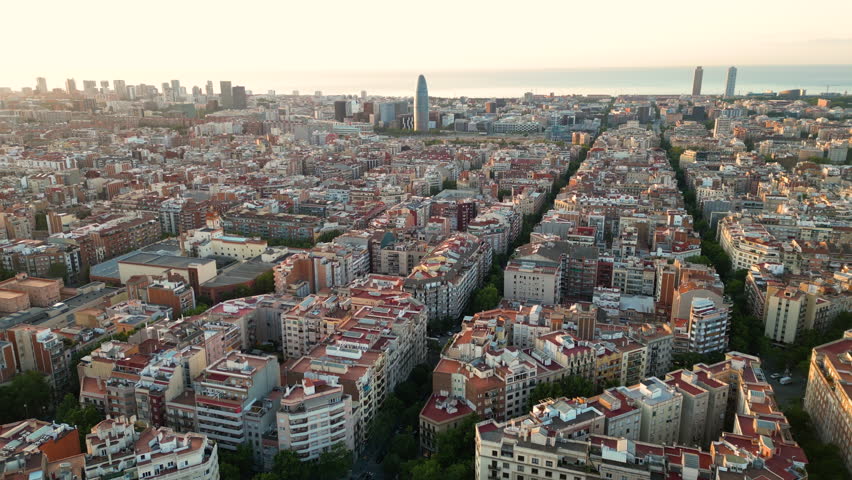 Aerial view of Barcelona Eixample residential district and famous Basilica Sagrada Familia at sunrise. Catalonia, Spain Royalty-Free Stock Footage #1109218631
