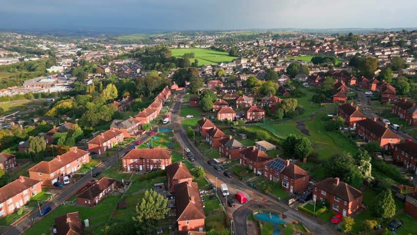 Yorkshire's urban charm: Aerial footage showcasing the red brick council housing, bathed in the morning sun, and a vibrant community in action. | Shutterstock HD Video #1109220493