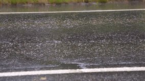 Close up of wet tarmac road with cars driving by - Powered by Shutterstock - Get 15% off with code: PIKWIZARD15