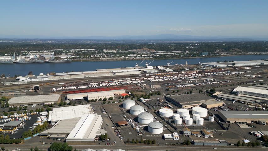 High angled static drone shot of industrial facilities along the Willamette river in downtown Portland, Oregon.