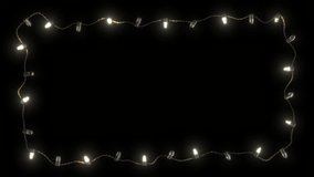 Christmas frame or New Year frame with bright flashing garland lights on a transparent background. Seamless animation. Christmas or New Year background animation
