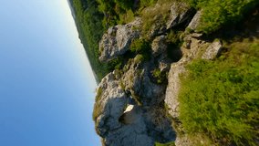 Vertical video. Amazing Jurassic highlands of limestone rocks in Poland by FPV drone.
