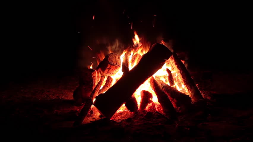 Night Bonfire Burns in the Dark Forest - Isolated on Black Background. Flaming Campfire at Nighttime. Place for Bonfire. Fire Pit Outdoors, Wood on Fire, Flying Sparks and Smoke - Static Shot Royalty-Free Stock Footage #1109235185