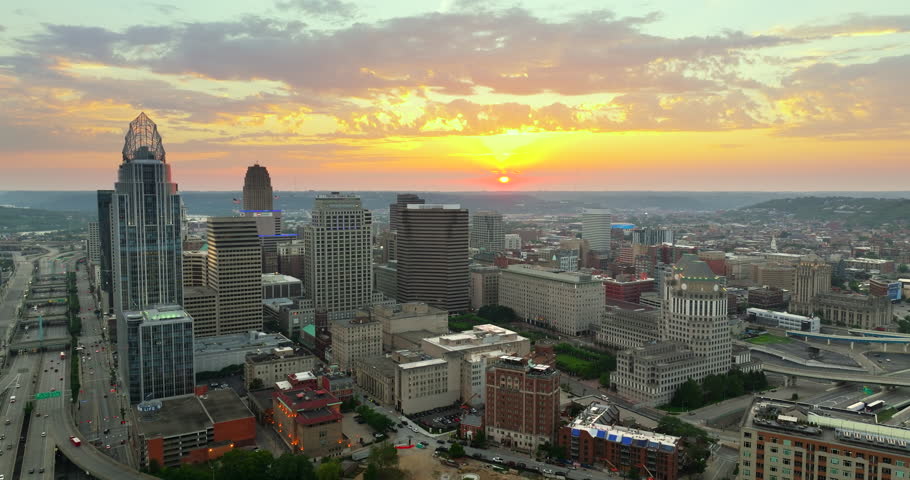 View from above of brightly illuminated high skyscraper buildings in downtown district of Cincinnati Ohio, USA. American megapolis with business financial district at sunset.