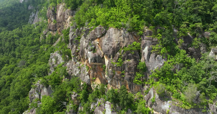 Rocky mountain cliffs with eroded stone surface in Blue Ridge Mountains near Chimney Rock State Park. Aerial view of Appalachian geological features Royalty-Free Stock Footage #1109236107