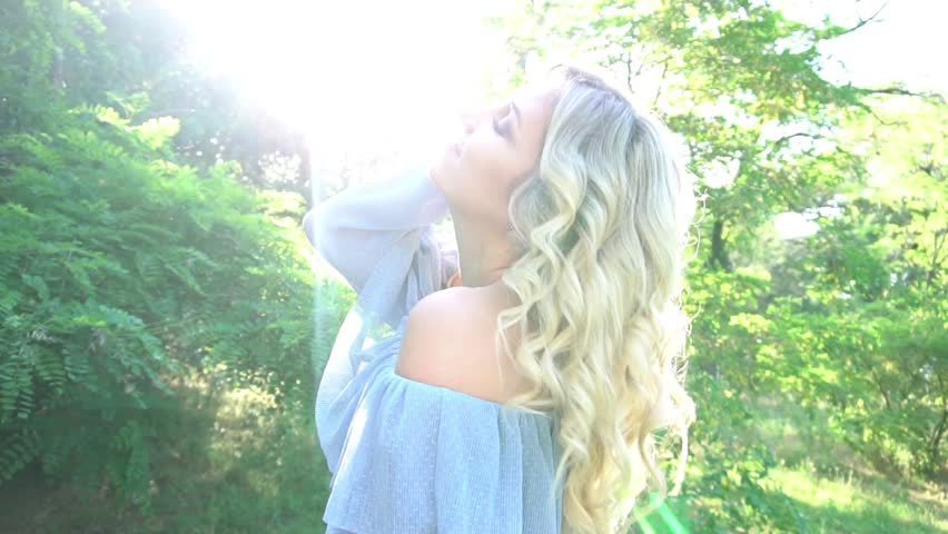 Slow Motion Close Up Portrait of Woman Standing on the Wind. Portrait of a beaut