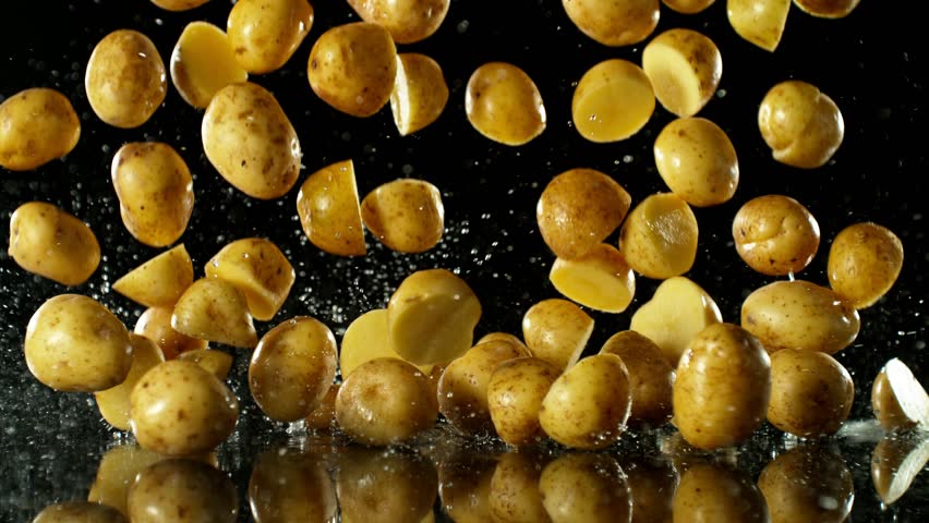 Super Slow Motion of Falling Potatoes on Black Background. Water is Splashing Around. Filmed on High Speed Cinema Camera, 1000fps. | Shutterstock HD Video #1109236971