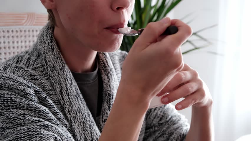 Woman eating yogurt. Middle-aged woman, healthy eating