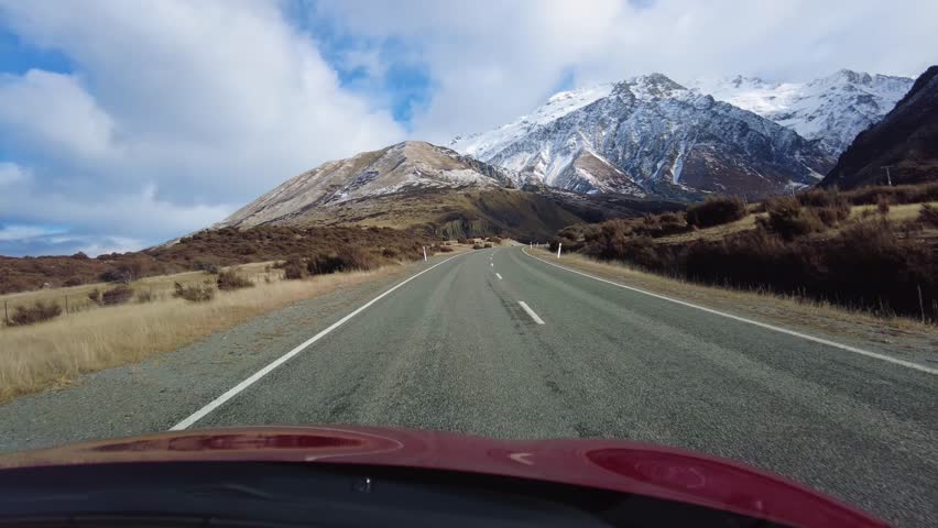 Mt Cook, New Zealand: Point of view of a car driving in the Mt Cook region in the southern alps in New Zealand south island on a sunny winter day.  Royalty-Free Stock Footage #1109246645