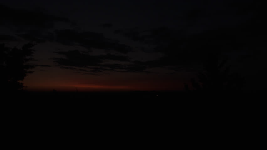 Sunrise over Iowa cornfield.  Timelapse as the sun comes up and the clouds go by.