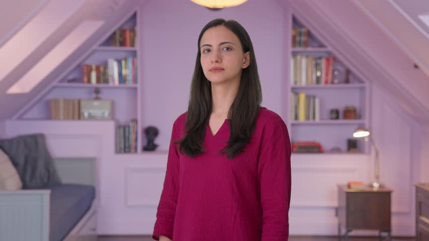 Portrait of Indian woman standing crossed hands